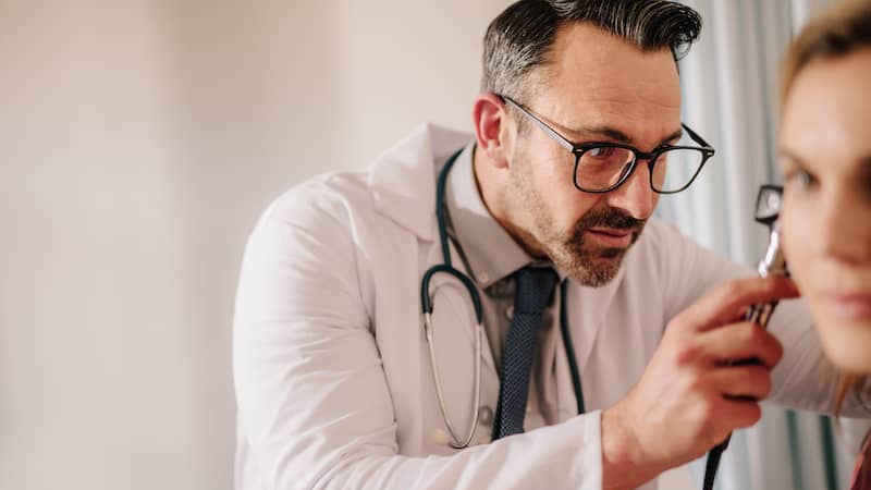 An audiologist with their patient